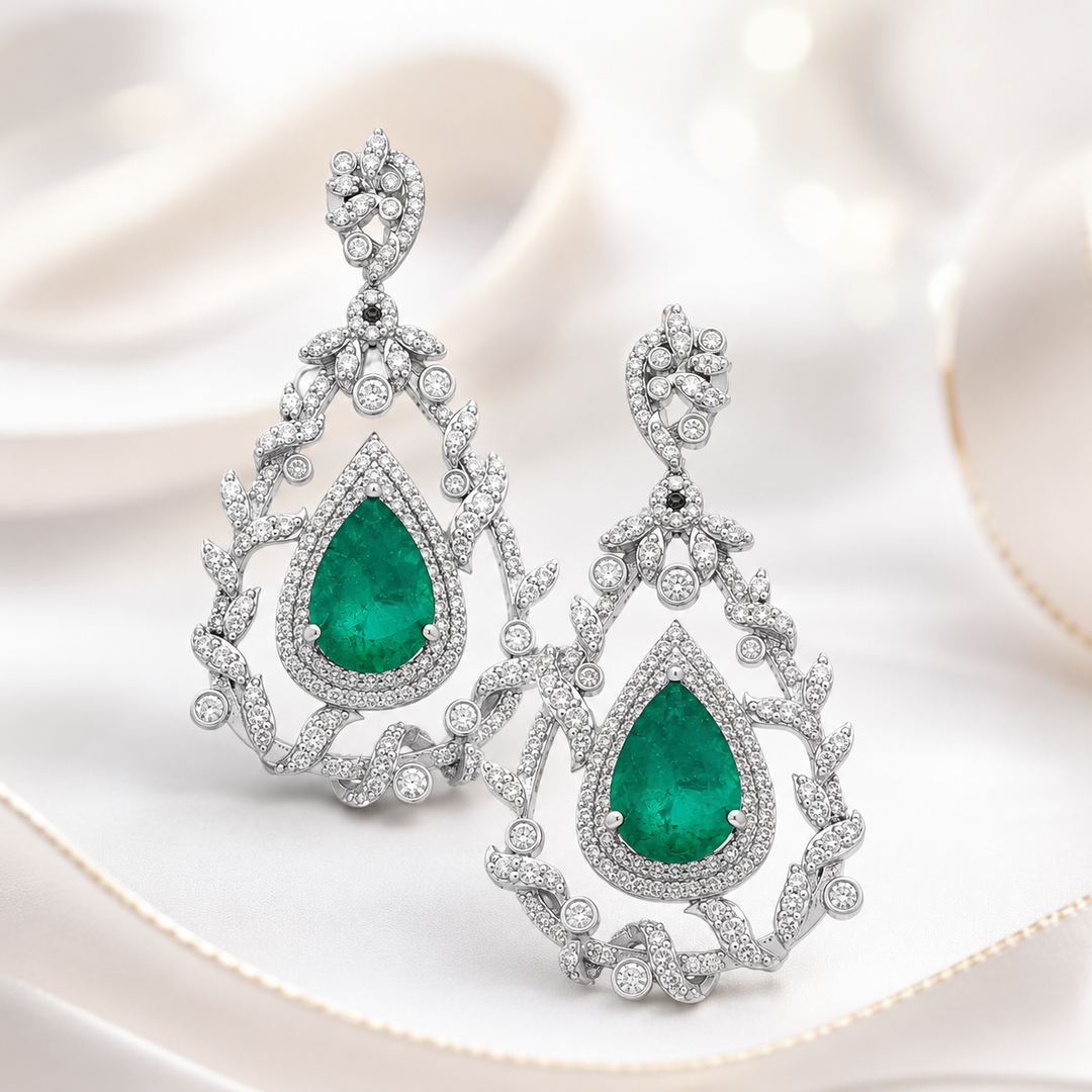 Dazzling 18K white gold earrings with scintillating diamonds and captivating emeralds