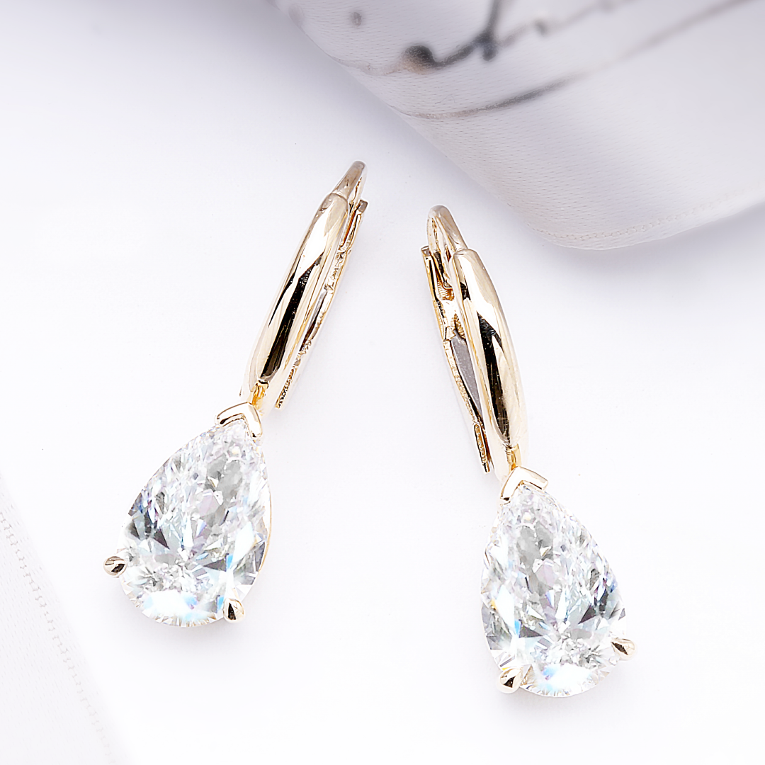 14K yellow gold earrings with pear shape lab-grown diamonds.
