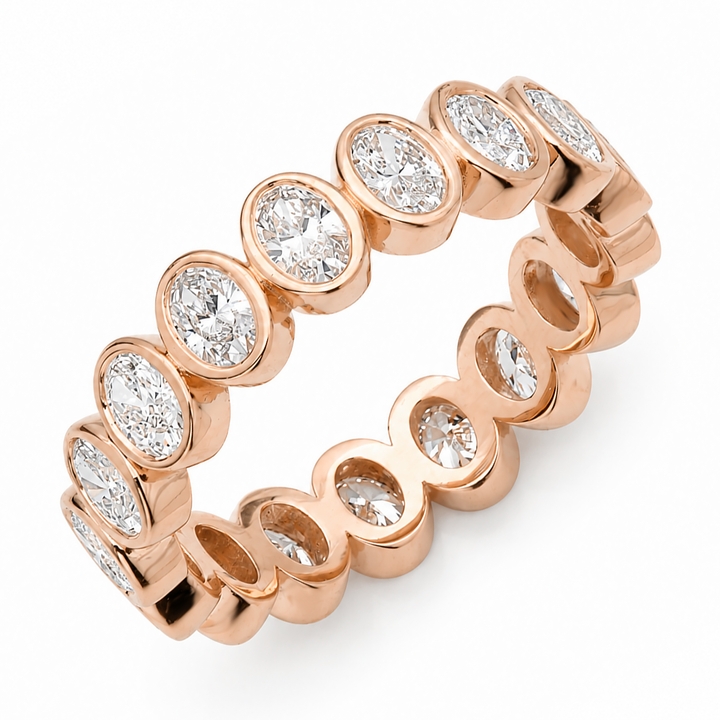 Oval cut diamond eternity band set in 18K gold band
