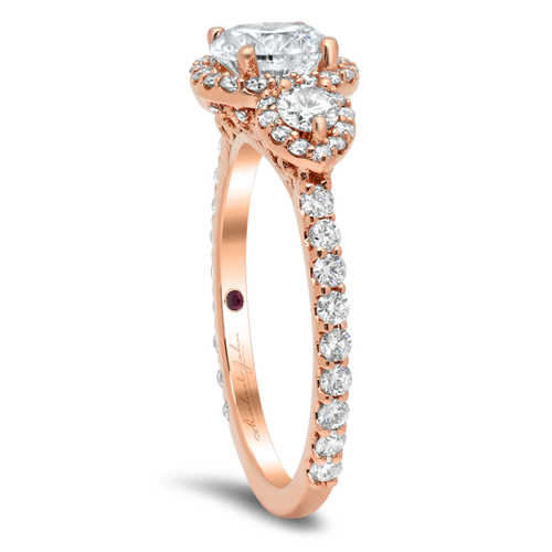 Diamond halo three-stone engagement ring with a total of 0.70 carat round cut diamonds on the halo and the 18K rose gold setting and also with 0.20 carat total side diamonds