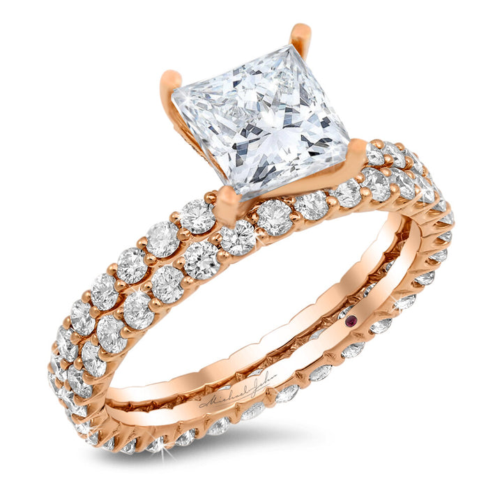 Two-piece diamond studded engagement ring with a total of 1.50 carat round cut diamonds set into 18K rose gold