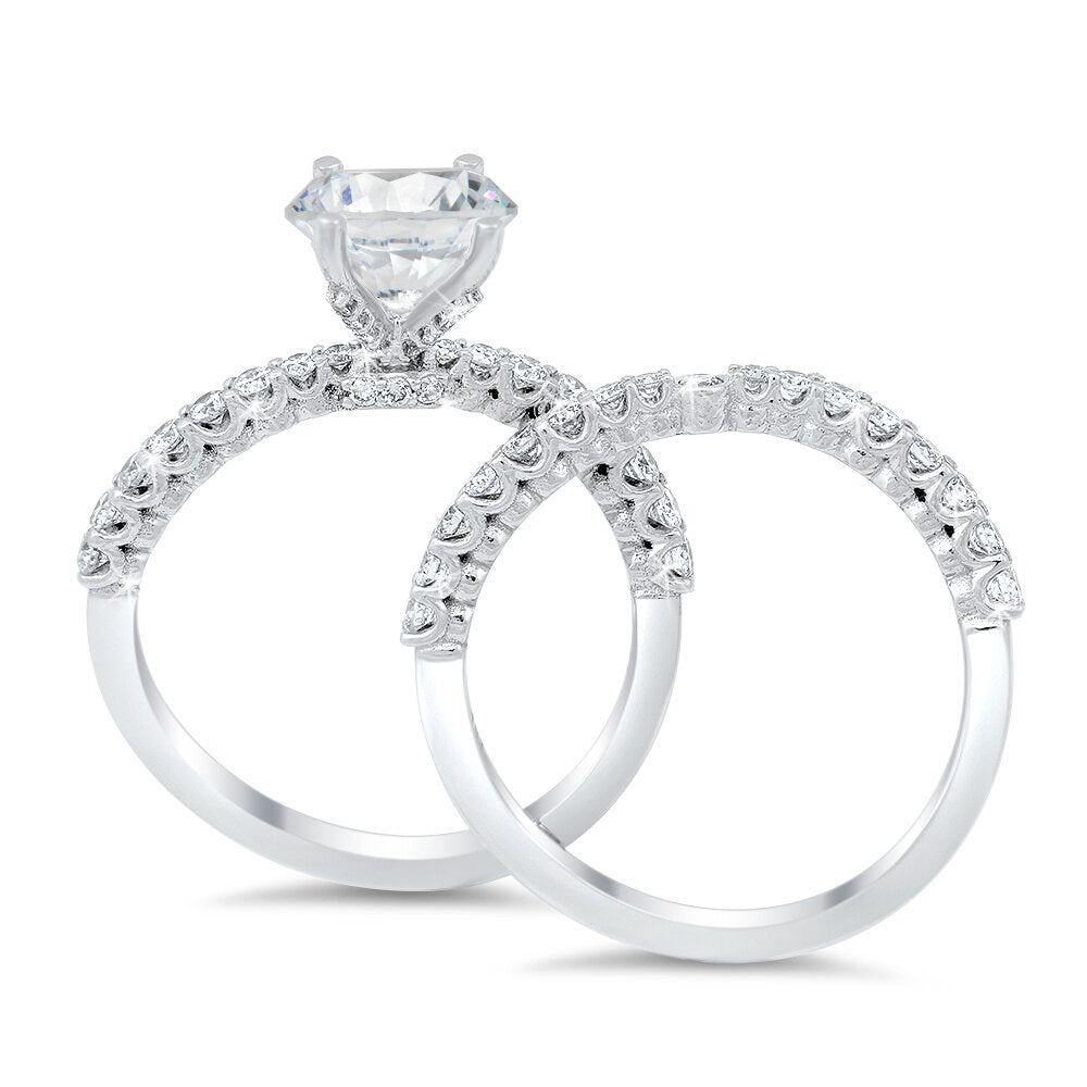 A curvy diamond engagement ring and the matching wedding band with a total of 0.70 carat round cut diamonds on an 18K white gold setting