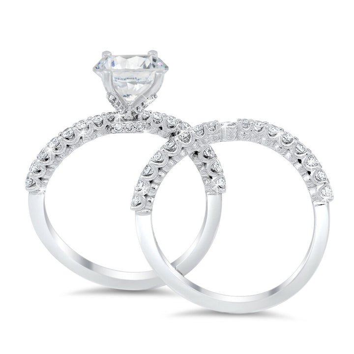 A curvy diamond engagement ring and the matching wedding band with a total of 0.70 carat round cut diamonds on an 18K white gold setting