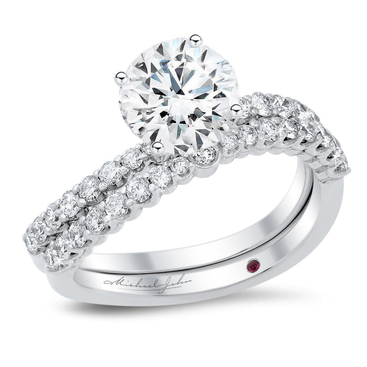 A curvy diamond engagement ring and the matching wedding band with a total of 0.70 carat round cut diamonds on an 18K white gold setting