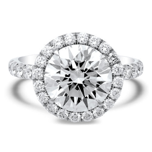 Diamond halo engagement ring with total of 1.10 carat round cut diamonds set in an 18K white gold setting