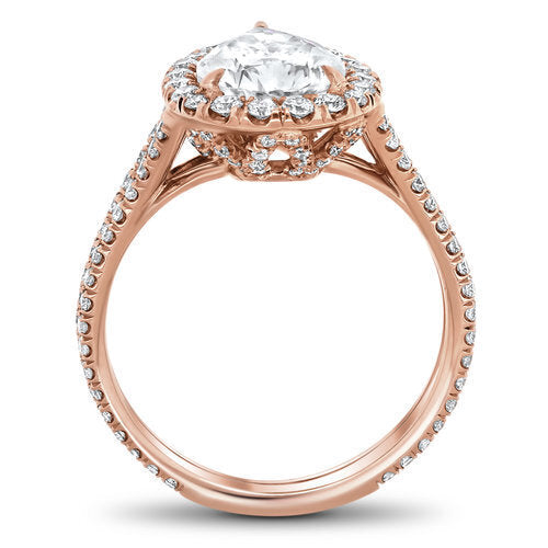 Split shank diamond halo engagement ring with a total of 0.80 carat round cut diamonds set on an 18K rose gold setting